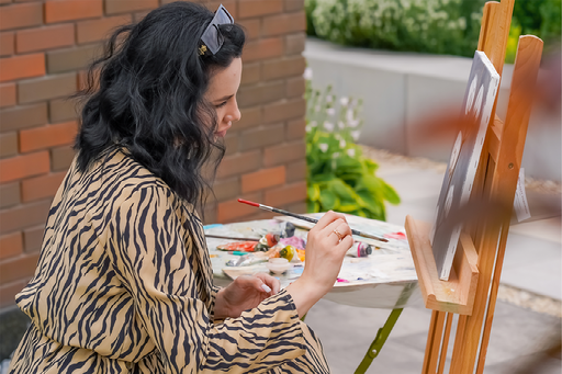 Woman painting a canvas at Art House Pasadena